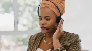 A customer service representative assisting a client at a call center